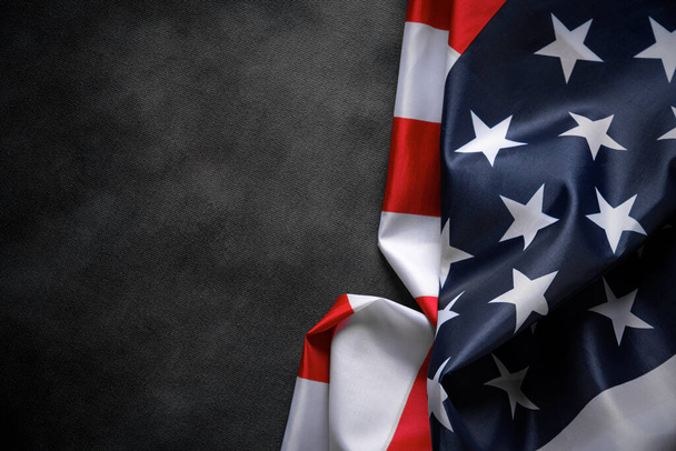 Flaga USA na ciemnym tle. Amerykańska flaga na tle ciemnego płótna dla patriotycznej koncepcji i narodowych uroczystości. - Zdjęcie, obraz