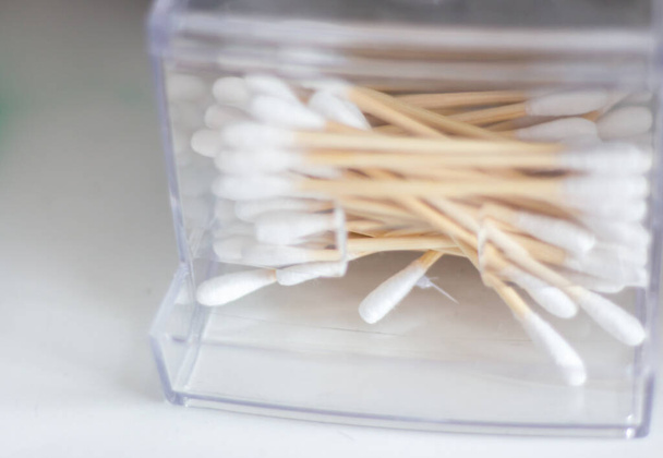 Cotton swabs in box. Healthcare accessory. Ear sticks in bathroom. Soft swabs close up. Hygeine tools. Personal sanitary concept. Cotton sticks for clean ears. - Foto, imagen