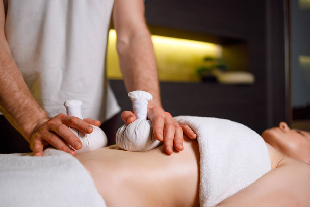 Abdominal massage with warm pindas at spa center - Fotó, kép