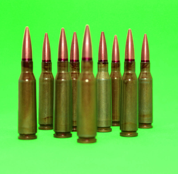 artridges for gun weapon with red lines on a bullets with sharpen and soft focus isolated on green screen  - Fotografie, Obrázek