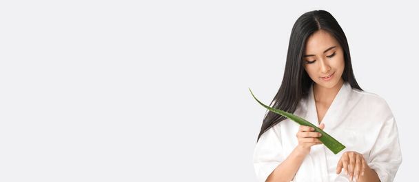 Beautiful Asian woman holding aloe vera on white background with space for text - Zdjęcie, obraz