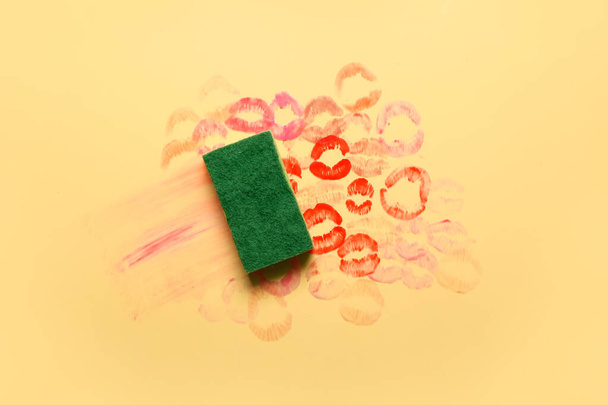 Cleaning sponge with lipstick kiss marks on color background - Valokuva, kuva