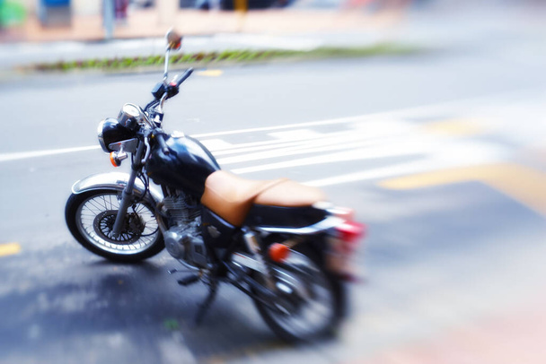 Ready to hit the road. a motorbike parked on the side of a road - Foto, imagen