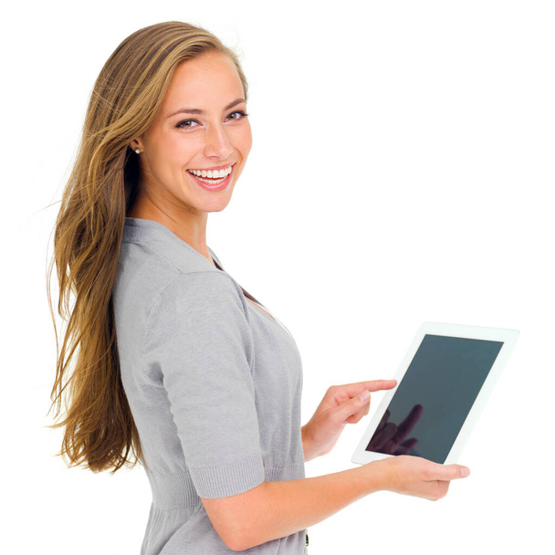 Shes got the hang of touchpad technology. Studio portrait of an attractive young woman holding a digital tablet - Foto, Bild