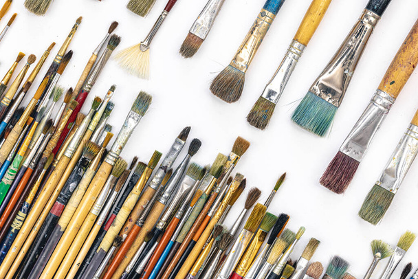 Many colored brushes for painting on a white background isolated, top view. - Foto, Imagem