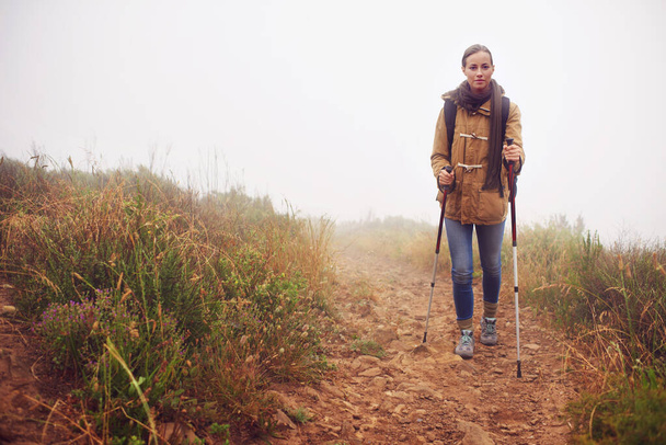The best exercise ever. Portrait of an attractive young woman hiking along a trail on an overcast day - Photo, image