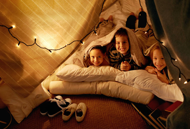We have an active imagination. three young children playing in a tent together - Zdjęcie, obraz