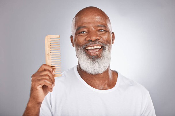 Senior black man with smile, comb and body hair, beauty and grooming with hygiene and cosmetic care against studio background. Hair care mockup, beard with portrait and face treatment and cosmetics. - Fotografie, Obrázek