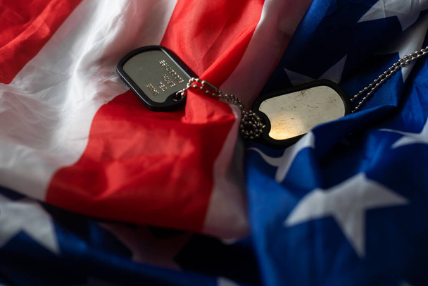 American flag and soldiers tags on background. Veterans Day Concept - Photo, image