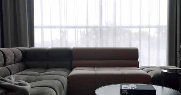 Luxury Modern House Interior With Corner Sofa and round table. Modern contemporary Minimalist living room with gray and brown furniture. Fashionable furniture. Cozy Modern Furniture Design. - Filmati, video