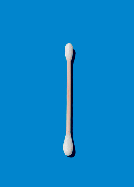 Ear stick, made of bamboo, on blue background. Zero waste concept. - Photo, image