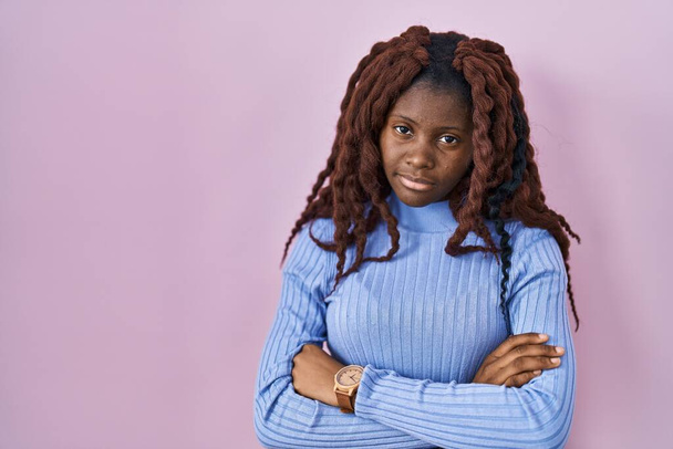 African woman standing over pink background looking sleepy and tired, exhausted for fatigue and hangover, lazy eyes in the morning.  - Foto, imagen