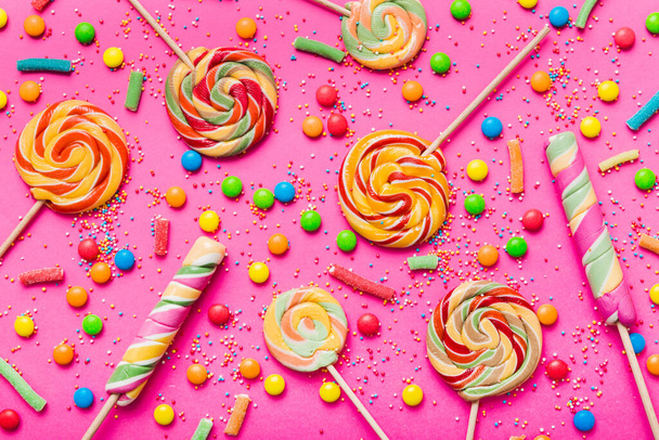 Tasty appetizing Party Accessories Happy Birthday Sweet. Different types of candies on colored background, copy space. Colorful birthday party background. - Photo, Image