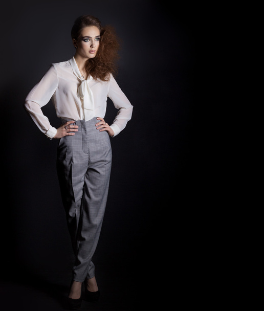 Beautiful girl in shirt and trousers in business style in the Studio on a black background, I'm a hair and make-up - Fotoğraf, Görsel