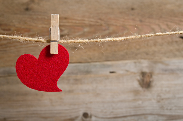 Red fabric heart hanging on the clothesline - Φωτογραφία, εικόνα