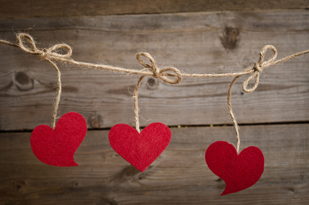 Three Red fabric hearts hanging on the clothesline - Фото, зображення