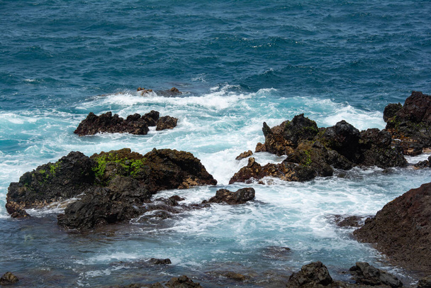 Rocks in the breakers on the coast of the Canary Island of Tenerife, Spain - Photo, image
