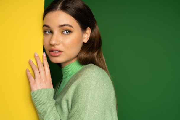 Pretty teen girl in jumper looking away on colorful background  - Fotó, kép