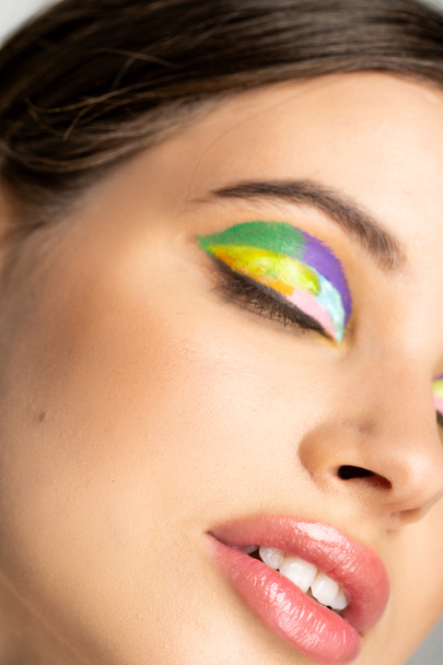Cropped view of teenage model with colorful visage and closed eyes  - Foto, Bild