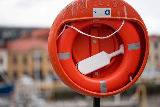 life buoy and lifebelt on the wharf in a city. Red lifebuoy in australia - Fotoğraf, Görsel
