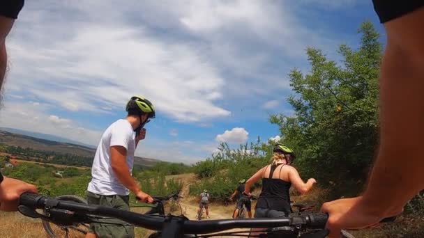 Группа людей, катающихся вместе на велосипеде по горной дороге в летнее время, вид от первого лица, замедленное движение - Кадры, видео