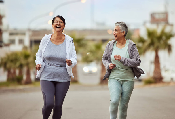 Fitness, city or friends running in a marathon challenge with sports performance goals on urban city street. Happy, runners or healthy senior women in a cardio workout, fun training or body exercise. - Foto, Imagen