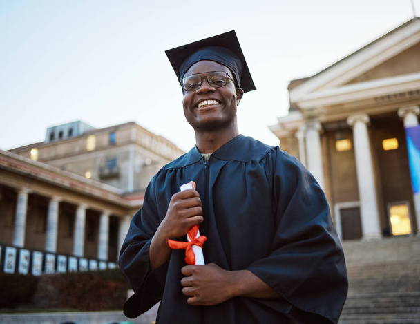 Achievement, diploma and portrait of a black man at graduation with college success, celebration and happy. Pride, smile and African graduate with a certificate after studying at university in London. - Photo, Image