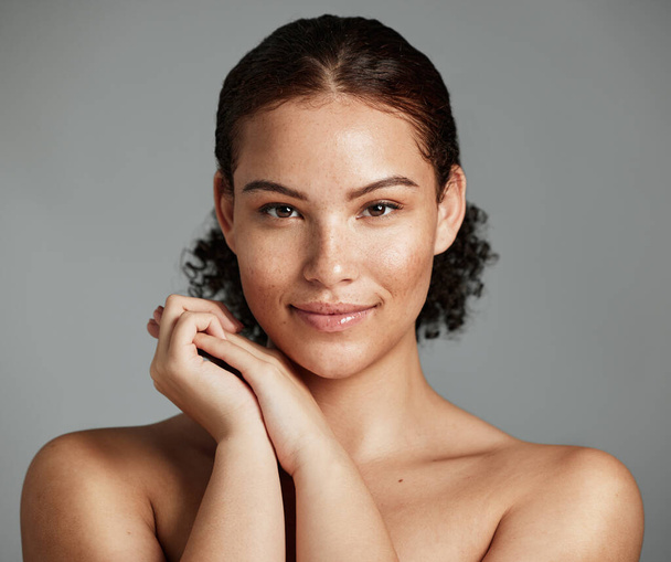 Health, natural and black woman skincare portrait for beauty cosmetic and glow treatment campaign. Healthy body care of model happy with beautiful freckles on face in gray studio background - Foto, imagen