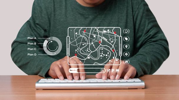 Mies, joka käyttää tietokoneen näppäimistöä etsiessään tietoa sijainti piste, kuvake karttoja ja löytää paikkoja online-järjestelmä, Yhteyslinja kartan yli, Navigointi käsite. - Valokuva, kuva