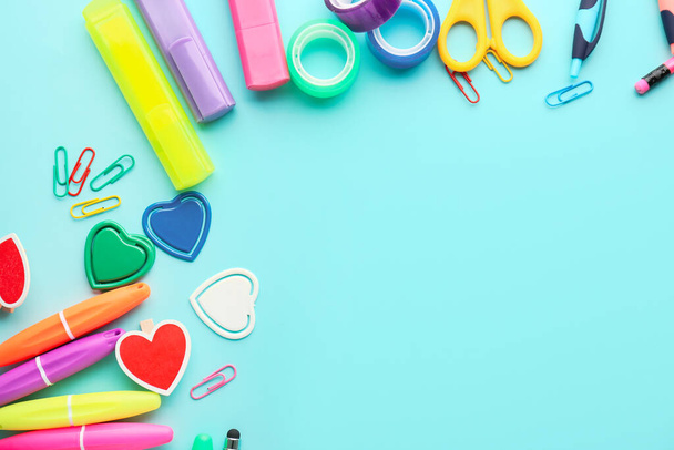 Set of stationery with colorful markers on color background - Foto, afbeelding
