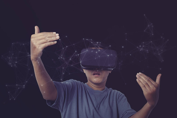 Business network communication and technology on workplace exploring the metaverse. Man wearing VR virtual reality Headset network connection line and data exchanges on neon color background. - Foto, imagen