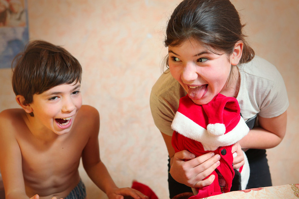 naughty brother and sister dress cat in santa klaus costume - Photo, Image