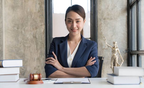 Attractive young lawyer in office Business woman and lawyers discussing contract papers with brass scale on wooden desk in office. Law, legal services, advice, Justice and real estate concept... - Φωτογραφία, εικόνα