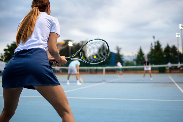 Portrait of happy fit young woman playing tennis at summer. People sport healthy lifestyle concept - Photo, image