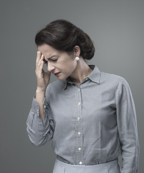 Woman with headache touching forehead - Foto, afbeelding