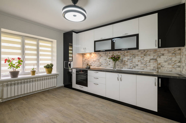 Interior renovation showcase of well designed modern trendy white kitchen, corner view - 写真・画像