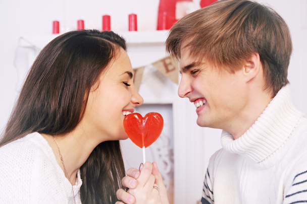 cheerful couple with candy - Photo, Image