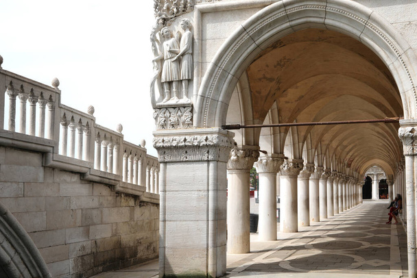 under the portico of the Doges Palace with the white columns in Venice in Northern Italy - Foto, Imagen