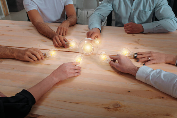 Business people connect lightbulbs as invention a new idea - Photo, image