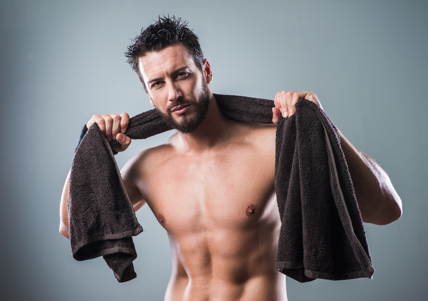 Muscular man drying body - Photo, image