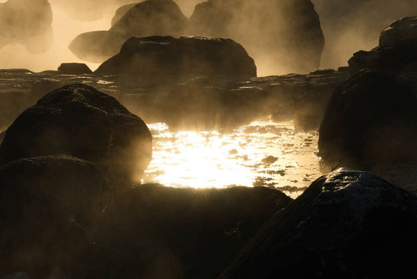 Hot springs and fog in Thailand with morning sunlight. Morning atmosphere at Chae Son National Park, Natural Hot Spring, Lampang Province, Thailand. - Photo, image