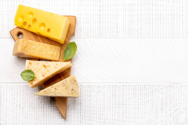 Various cheese on board. Flat lay with copy space - Zdjęcie, obraz
