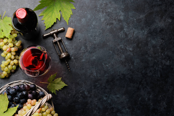 Red wine glass and grape in basket. Flat lay with copy space - Photo, Image