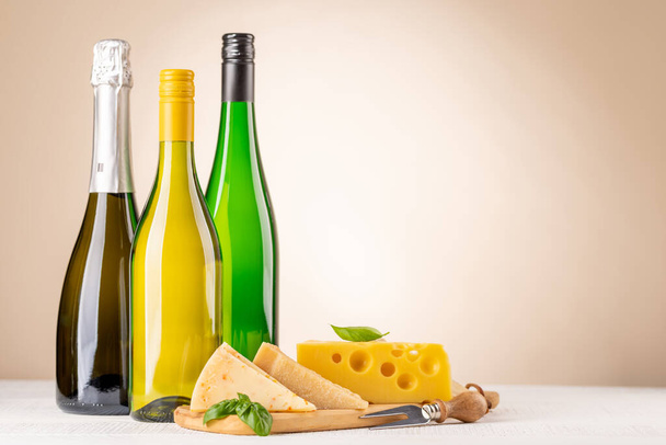 Various cheese on board and white wine. With copy space - Foto, Imagen