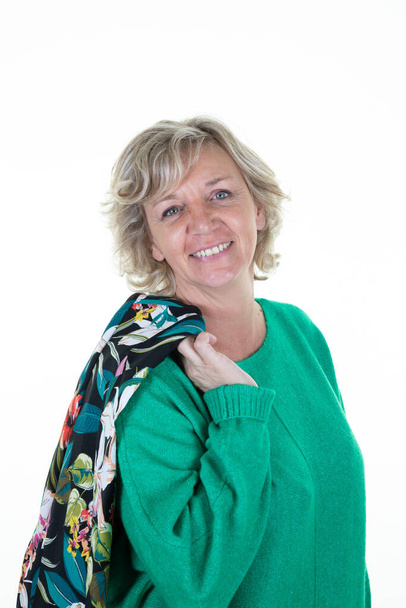 portrait of pretty blond senior happy woman jacket over the shoulder smiling on white background - Fotoğraf, Görsel