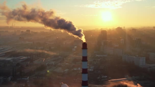 Aerial drone view of thermal power plant in Chisinau at sunrise, Moldova. View of pipe with felling steam, cityscape - Filmmaterial, Video