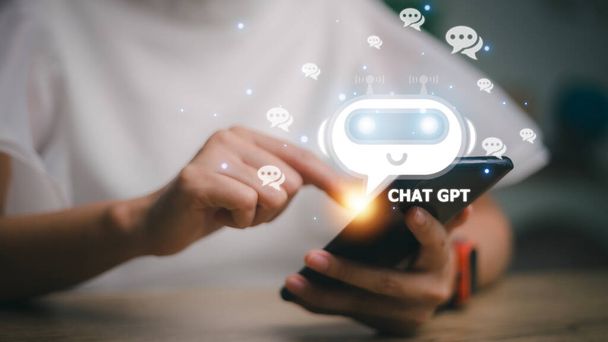 ChatGPT Chat with AI or Artificial Intelligence. woman chatting with a smart AI or artificial intelligence using an artificial intelligence chatbot developed by OpenAI. - Foto, afbeelding