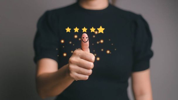Customer satisfaction concept. Hand with thumb up Positive emotion smiley face icon and five star with copy space. - Fotoğraf, Görsel