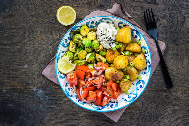 Brussel sprouts and tomato salad bowl, healthy and balanced food with baked potatoes - Fotografie, Obrázek
