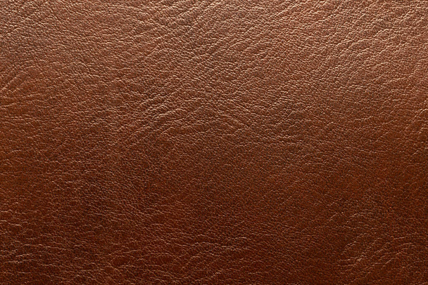 Brown leather and a textured background. - Foto, Imagen